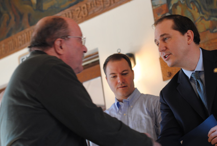 Jeffery Dzialak shakes hands with New York State Sen. Rob Ortt and Assemblyman Mike Norris, who helped recognize the fort's volunteers at the annual breakfast.