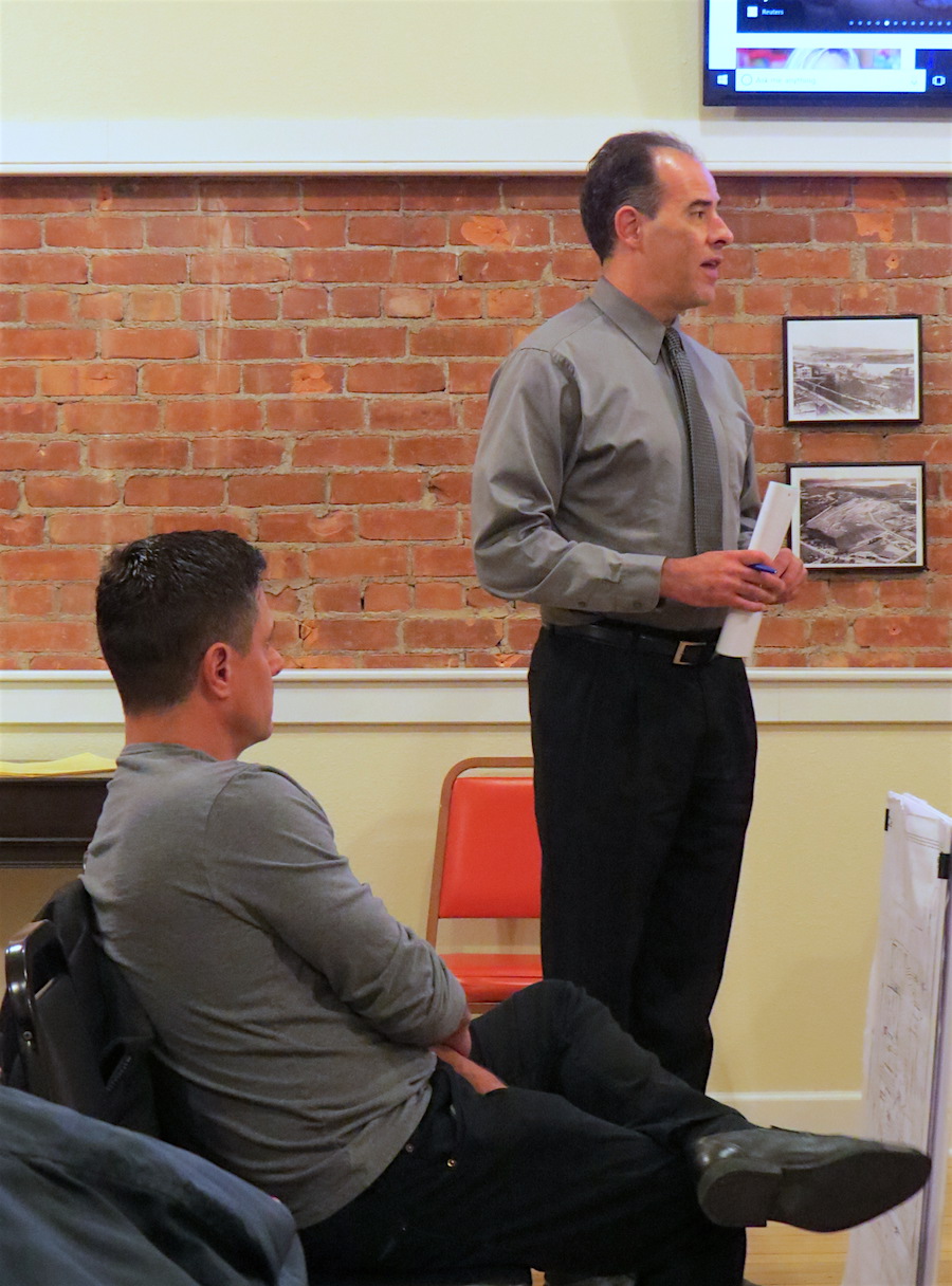 Attorney Sean Hopkins addresses the Village Board as William Paladino listens.