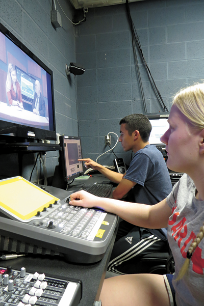 Niagara Falls High School seniors and Our Schools Channel media interns Allie Hubert and Christian Meranto work on a 