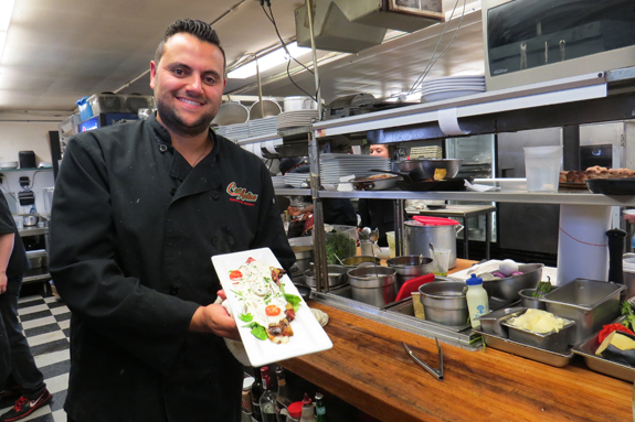 Pictured in the kitchen, chef Calogero Soldano works to prepare dinners for a full house.