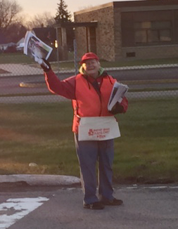 Pictured, volunteer Jean Peters sells newspapers on Kids Day in support of Women's and Children's Hospital.