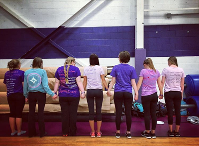 Alpha Sigma Alpha members walk around the gym.