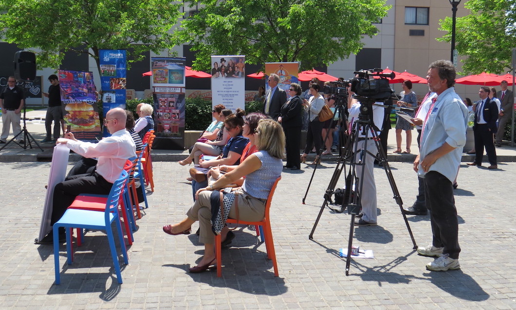 The press conference crowd listens intently.