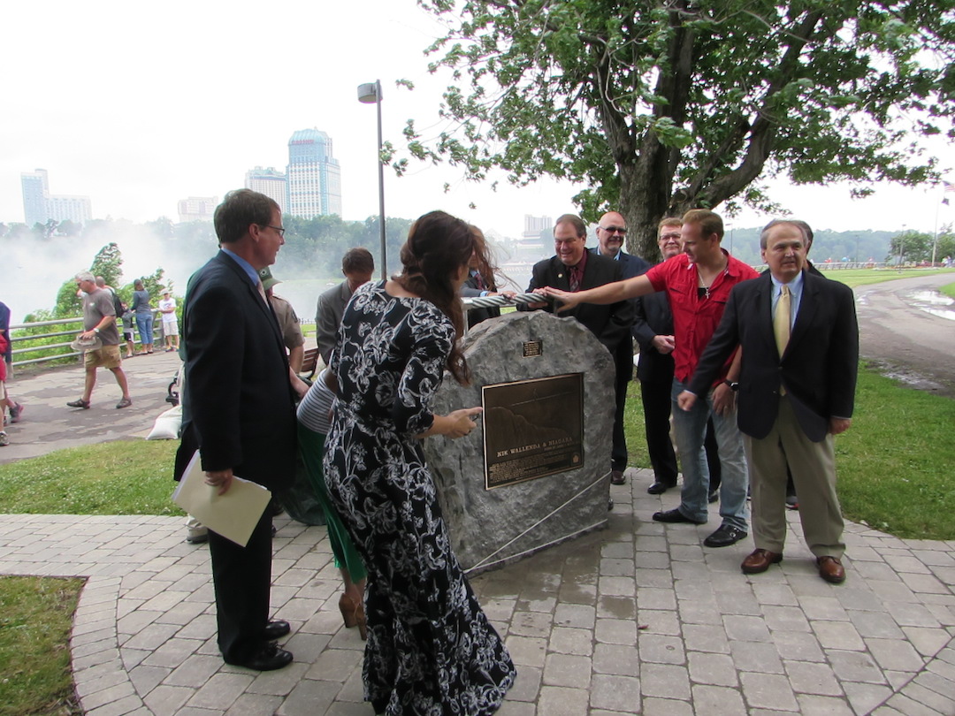 Nik Wallenda stands in front of a plaque mounted in his honor in Niagara Falls.