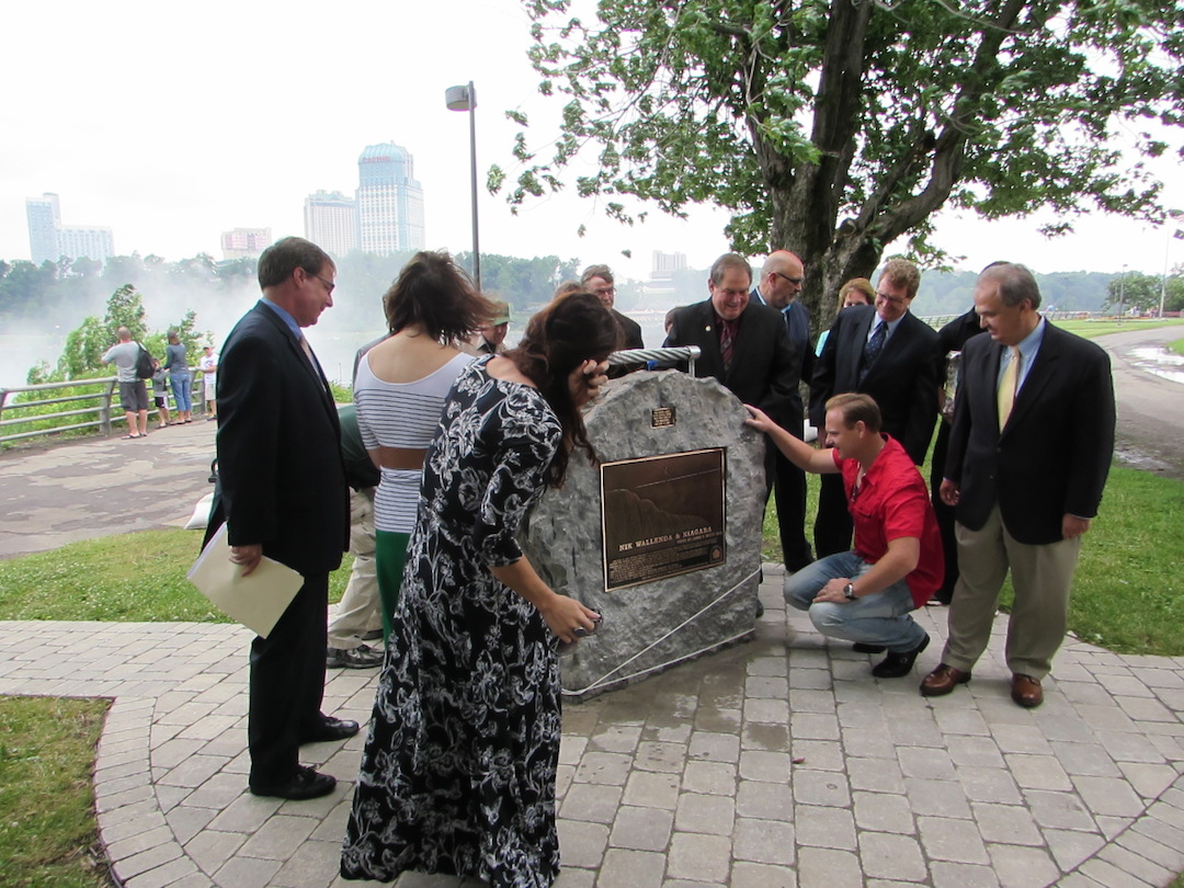 Nik Wallenda stands in front of a plaque mounted in his honor in Niagara Falls.