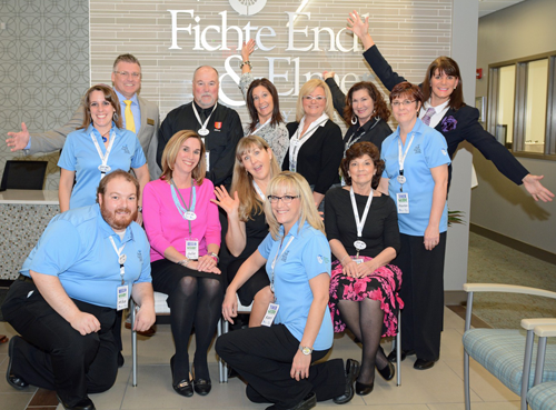 Staff members of Fichte Endl & Elmer Eyecare pose for a group shot at the grand opening celebration for their new facility on Porter Road.