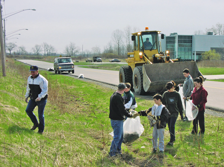 Volunteers, including Cub Scouts and town officials, participate in a past Liberty Drive Cleanup event.