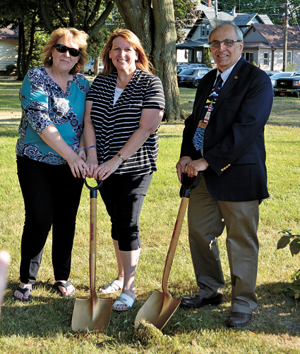 Project co-chairs MaryBeth Kupiec (left) and Paula Benedyczak break ground at Brauer Park alongside North Tonawanda Mayor Arthur G. Pappas.