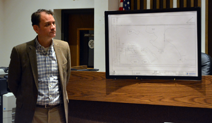 Attorney Adam S. Walters, representing National Fuel, stands with dehydration facility's initial sketch plan.