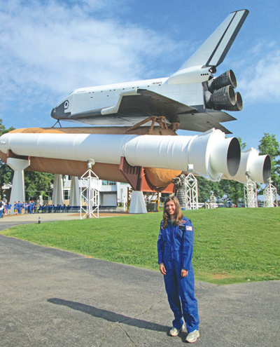 Holy Ghost Lutheran School teacher Sara Poreda is shown in front of the Space Shuttle Pathfinder.