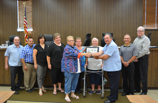Town Board members pose for a photo with owners and staff of Marsh's General Store to acknowledge the store's 75th anniversary.