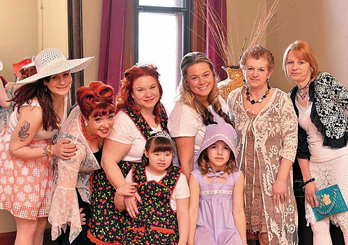 Michele Krienbuhl (second from right) of Michele's Motif Boutique and Gift Shop, stands with her fashion show team. They are decked out in her homemade aprons and other clothing offered at her business on Webster Street in North Tonawanda. (Photo contributed by Michele Krienbuhl)