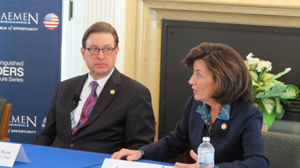 Daemen President Gary A. Olson listens to Lt. Gov. Kathy Hochul.