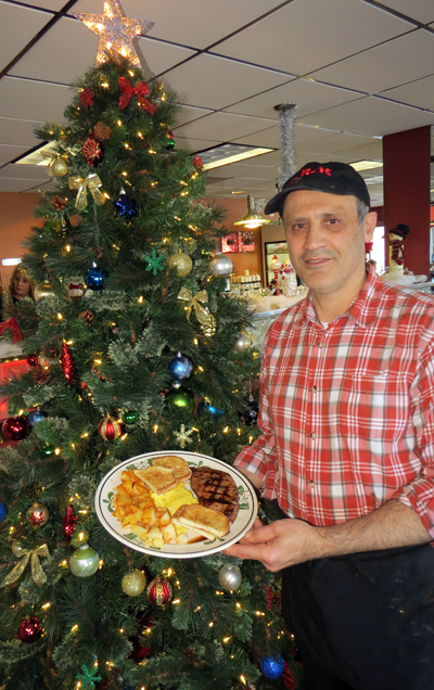 Bechara Cobti proudly displays Syros' famous steak and eggs. The dish is normally $10.49, but many mornings it's offered at a special price.