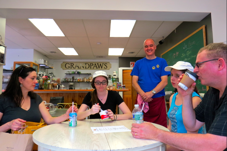 The McGuire family from Williamsville (seated) enjoys Grandpaws Café for Good as owner Andrew Bell looks on. Pictured, from left, are Noreen, Lauren, Brooke and Terry.