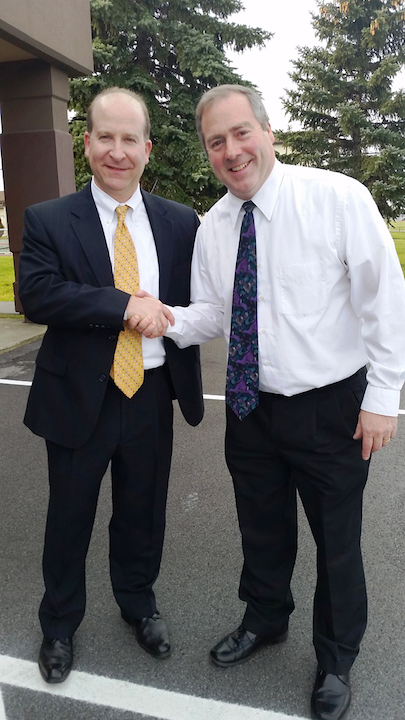 FBI Special Agent in Charge Adam Cohen shakes hands with David Whalen, project director of Niagara University's first responders disability awareness training program.