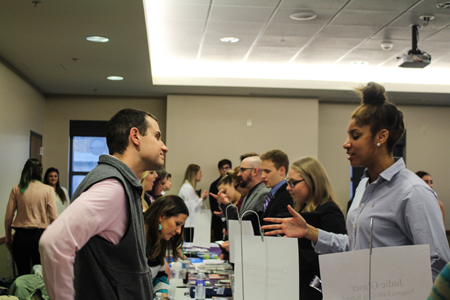 NU student Paige Mosley chats with Christian Hoffman, communications and development manager at Community Missions.